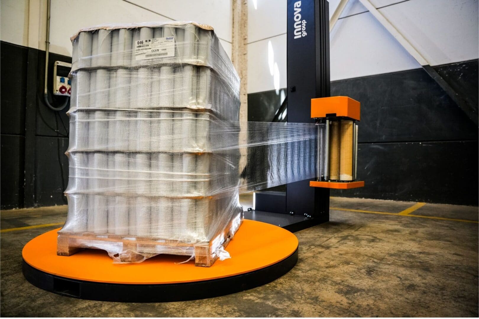 Turntable wrapper designed to fit different pallet sizes and factory spaces